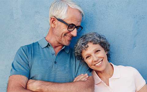 smiling white-haired man and woman 