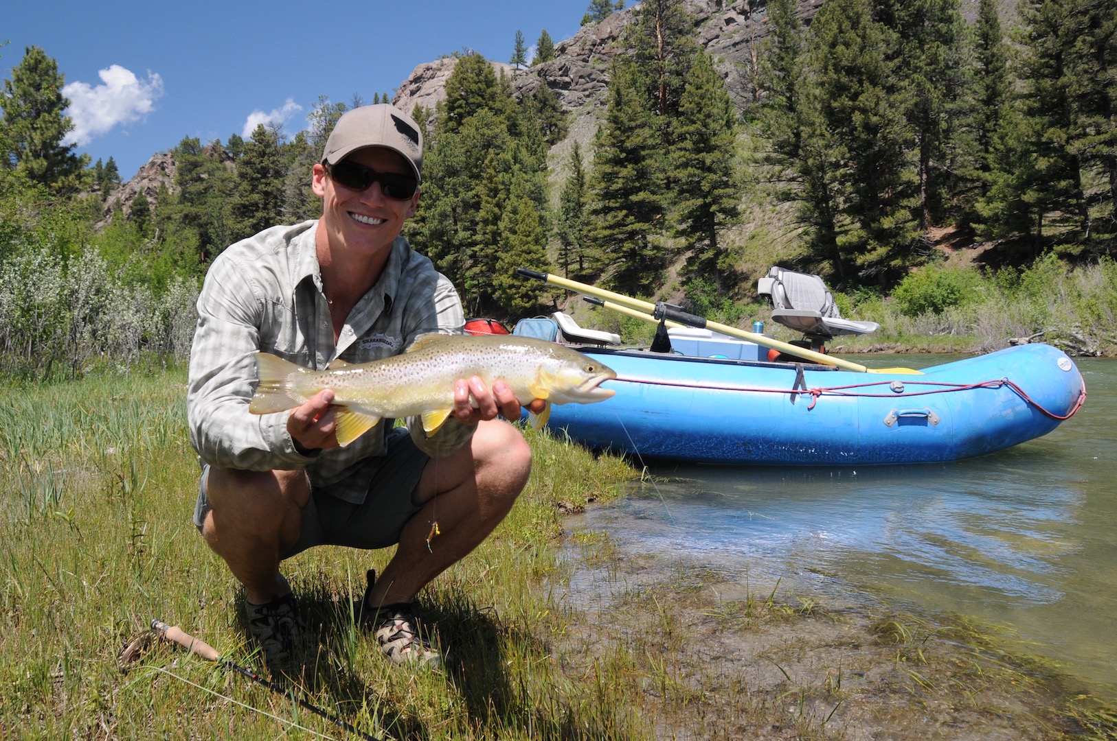 Dan McFarland, DDS with a fish in his hands and mountains in the background