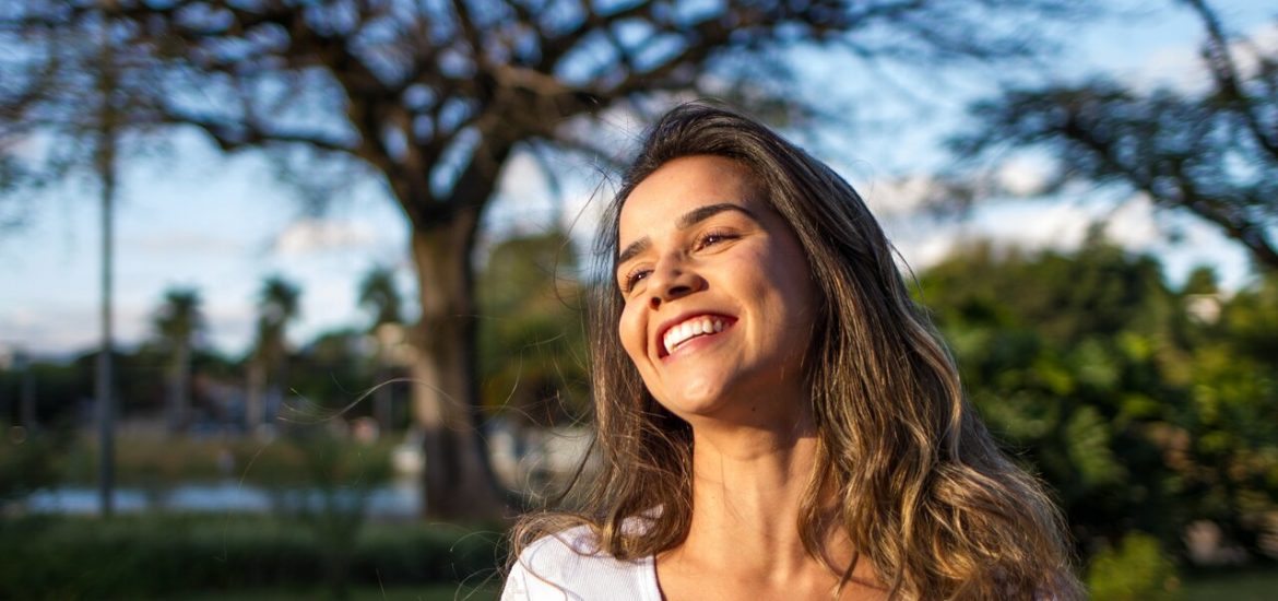 smiling woman wearing a white top