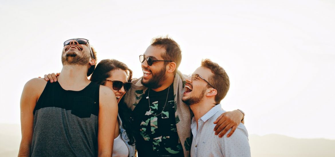 friends holding each other laughing in a group