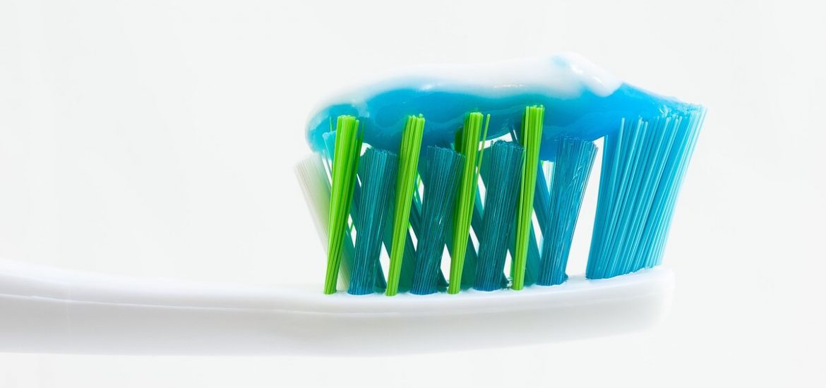 Close-up of a toothbrush with toothpaste in high key, shot against a white background