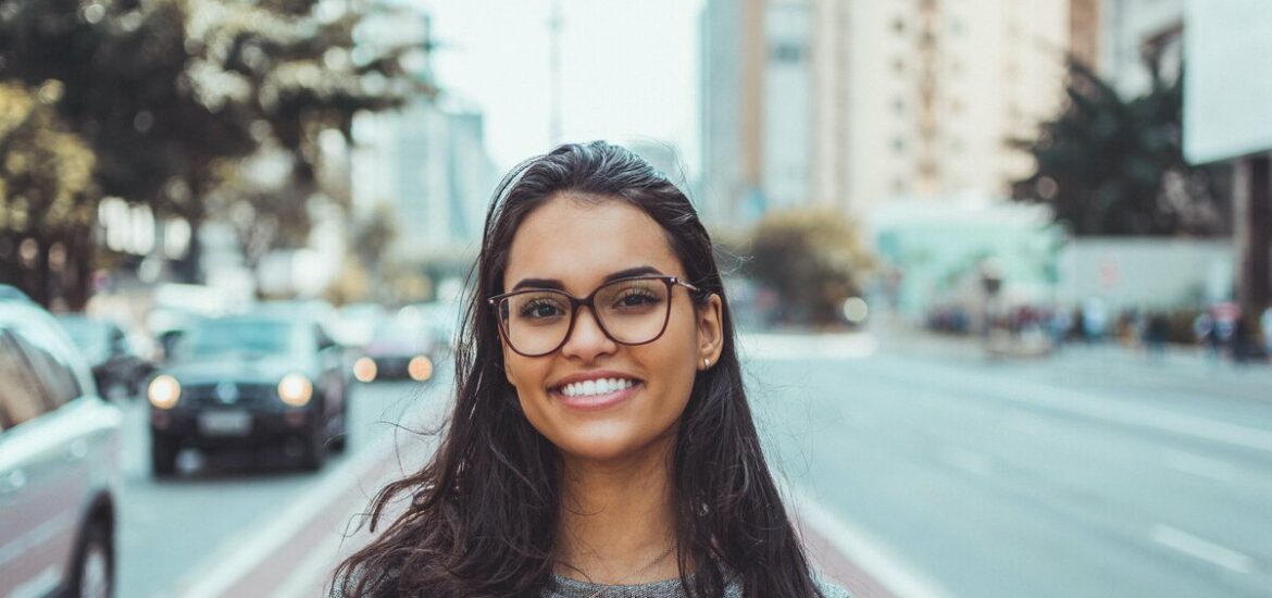 smiling women wearing black glases