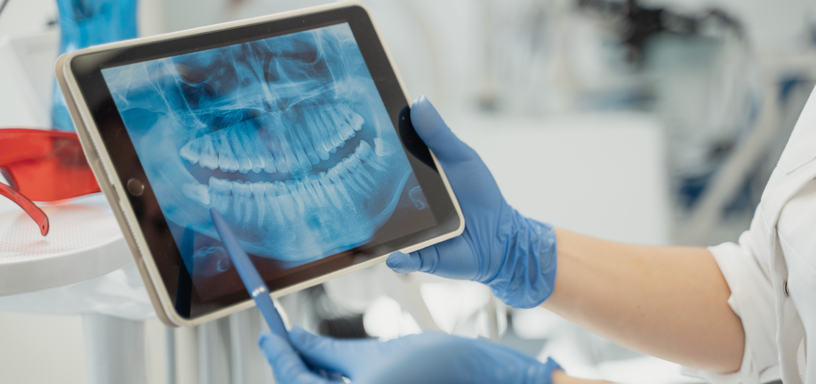 Dentist showing x-ray to patient on tablet